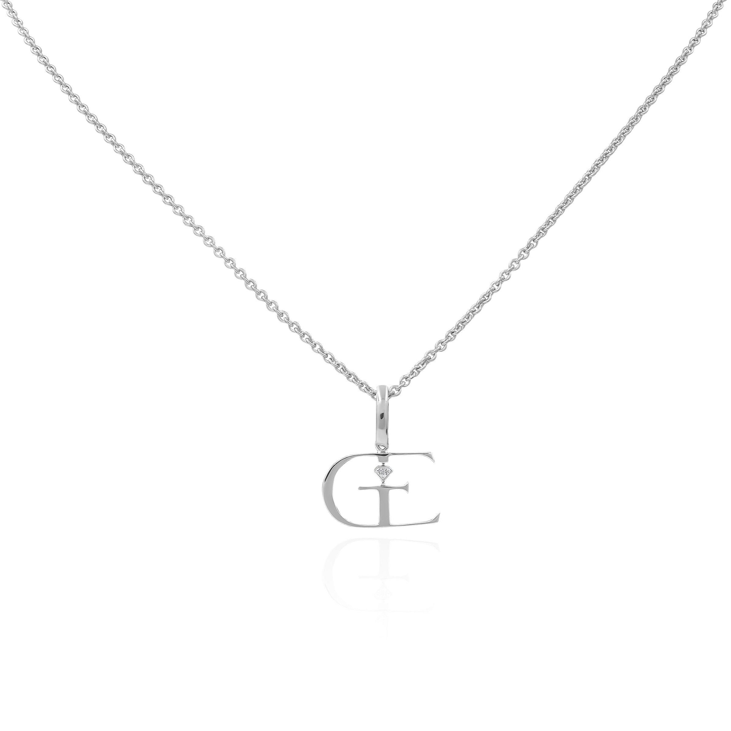 white gold necklace with a name plate pendant