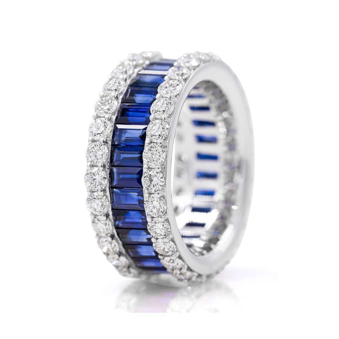 A white gold band ring featuring alternating blue sapphire stones and white diamonds.