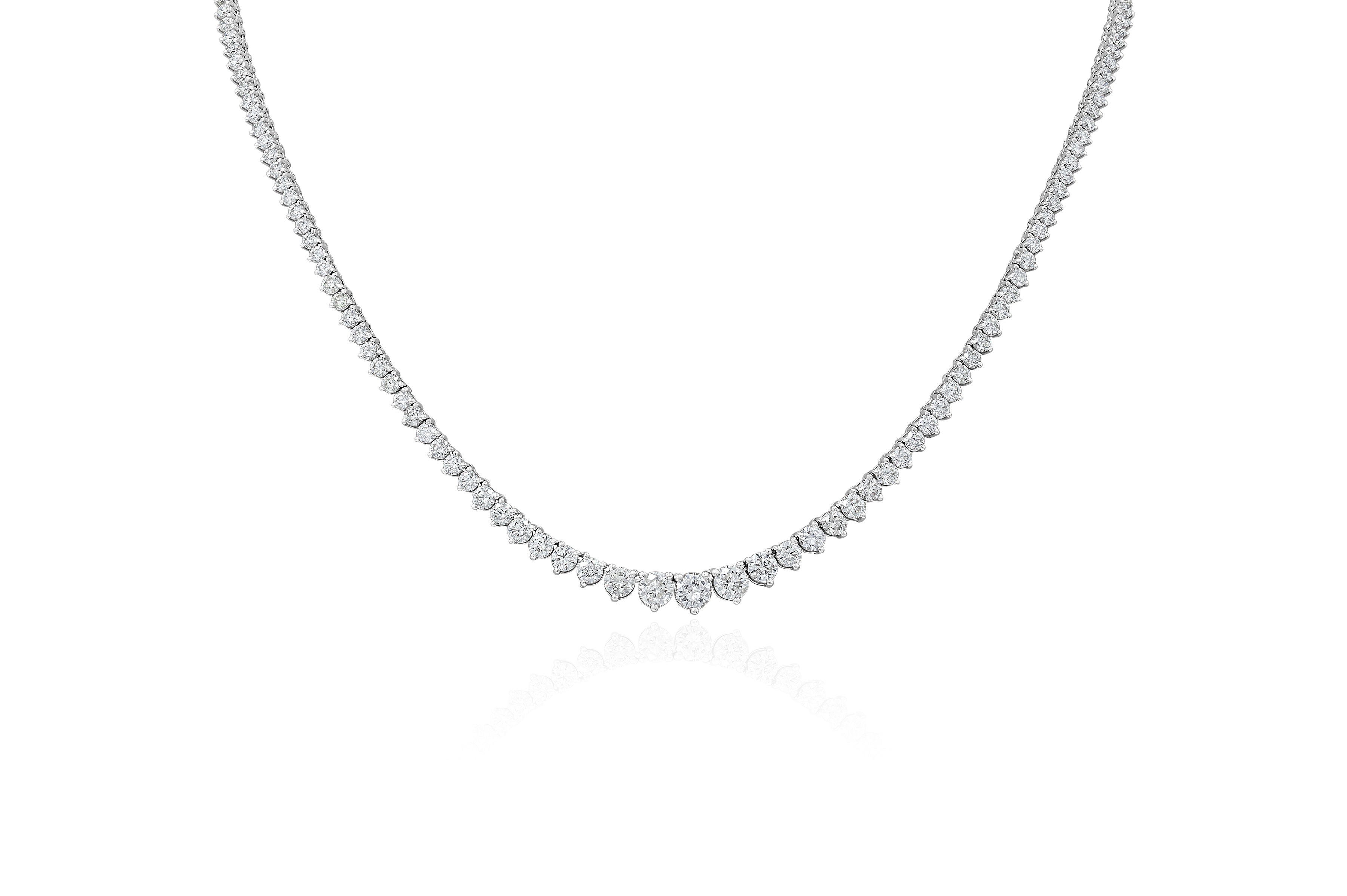 A white gold graduated diamond necklace with a series of diminishing diamond sizes from the sides towards the center.