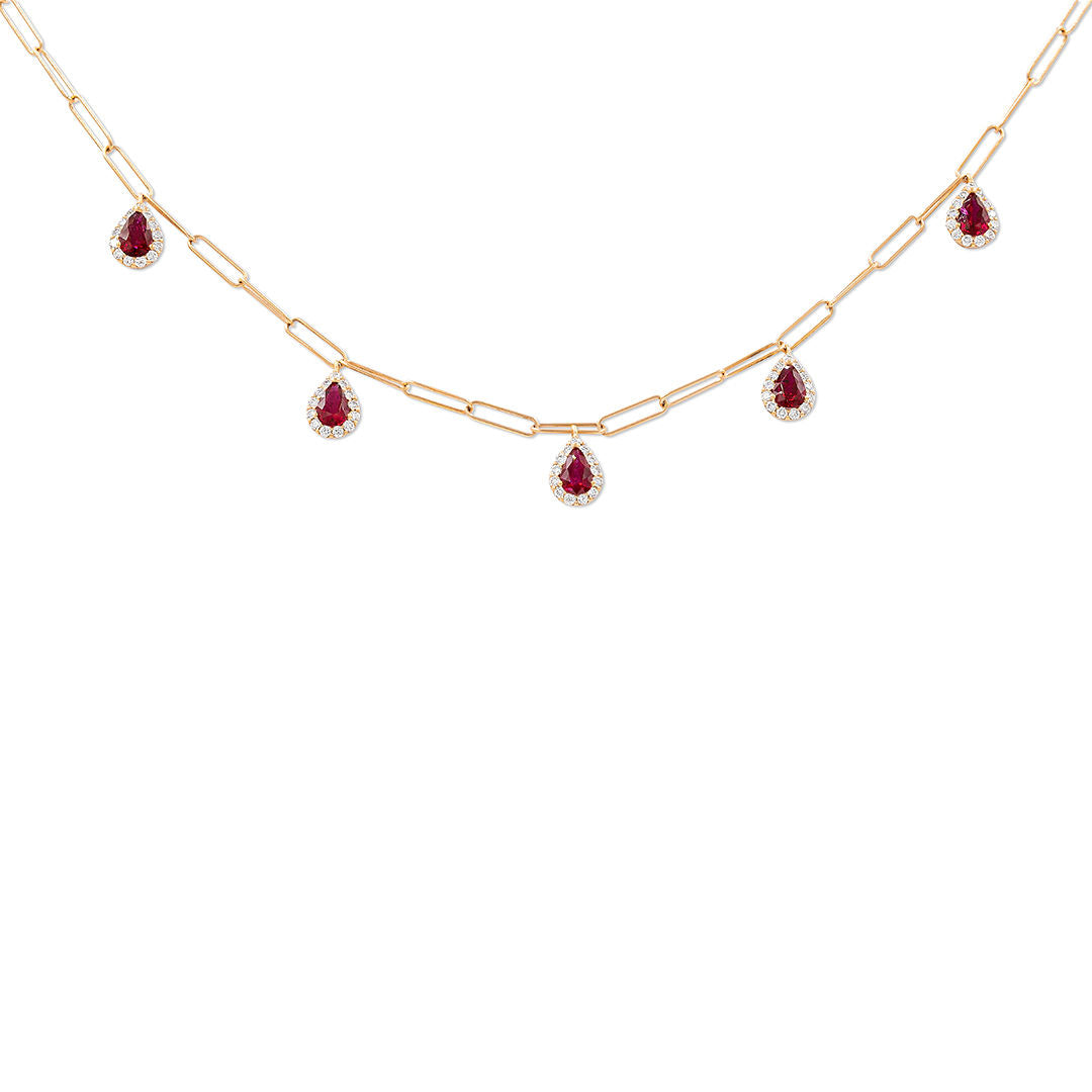 A gold necklace with pear shape ruby pendants and white diamond halos on a chain.