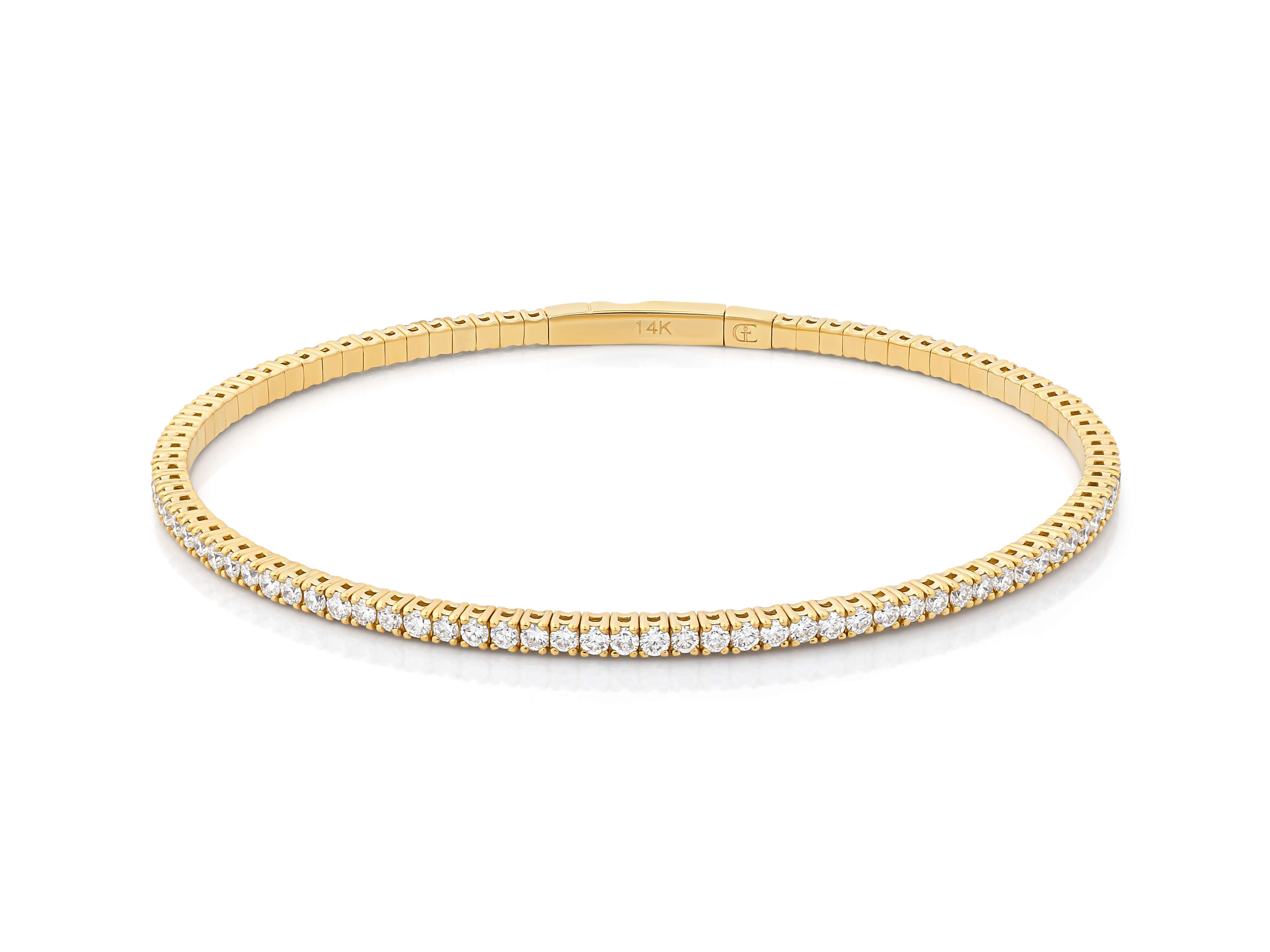 A yellow gold diamond flex bangle bracelet with half way coverage, showcasing multiple small diamonds set in a metallic band.