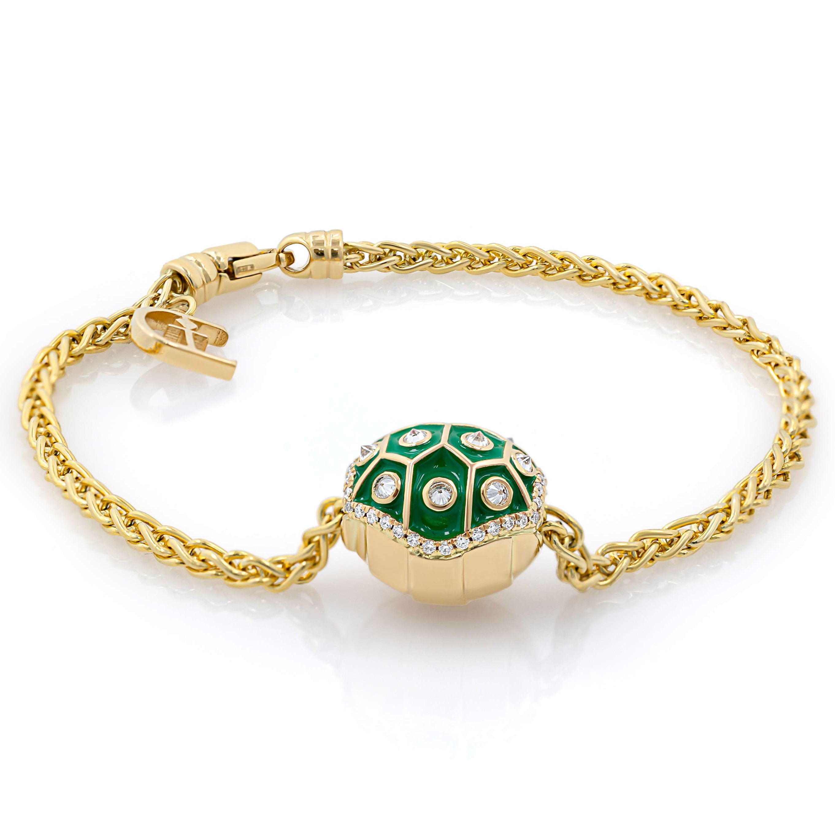 A gold bracelet featuring a sliding bowser shell charm with diamond accents.