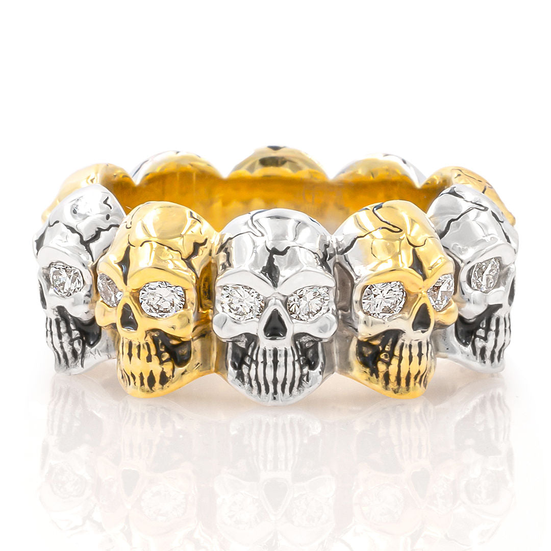 A gold two-tone skull eternity band with diamond eyes and enamel finish.