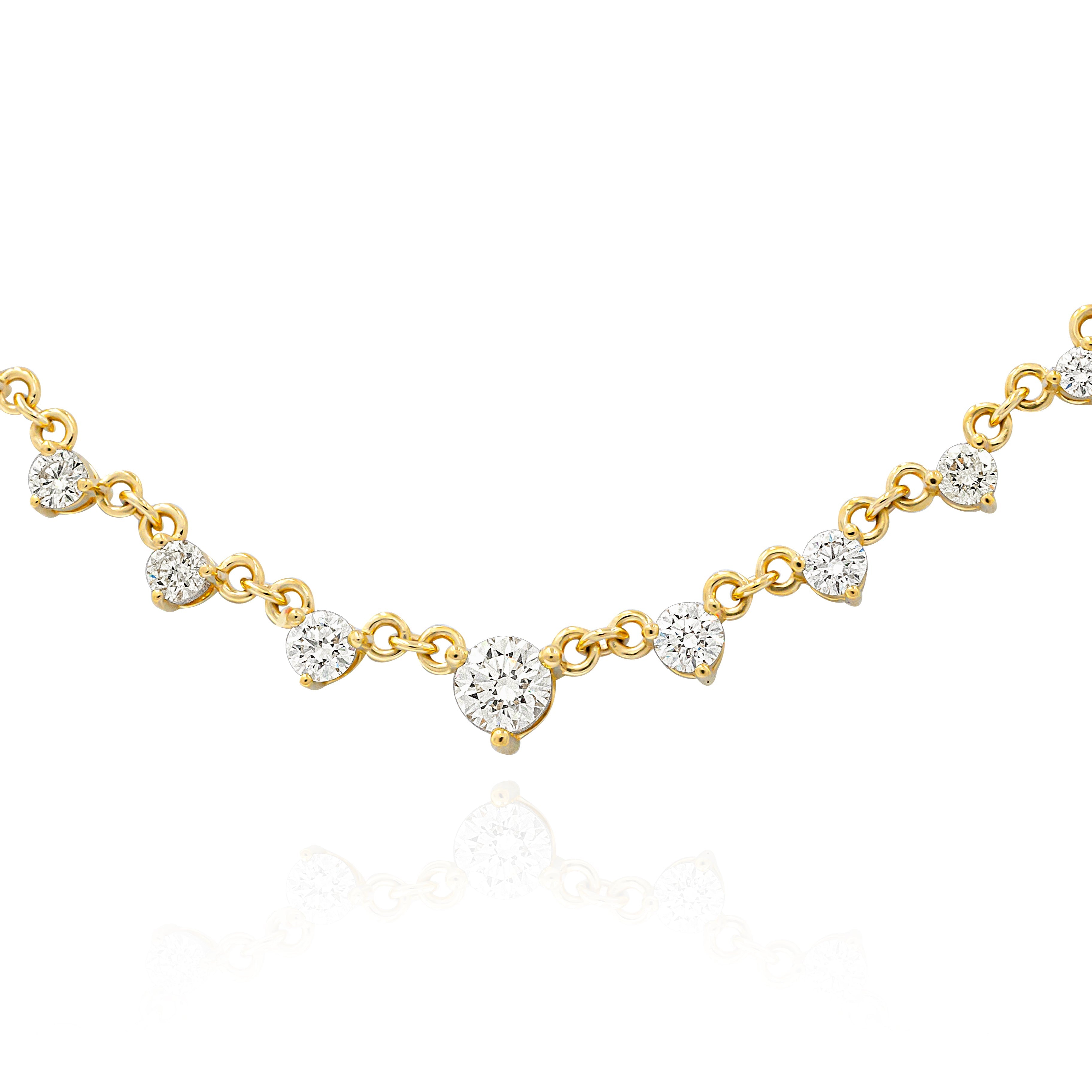 A dangling diamond necklace with yellow gold chain and multiple diamond pendants.