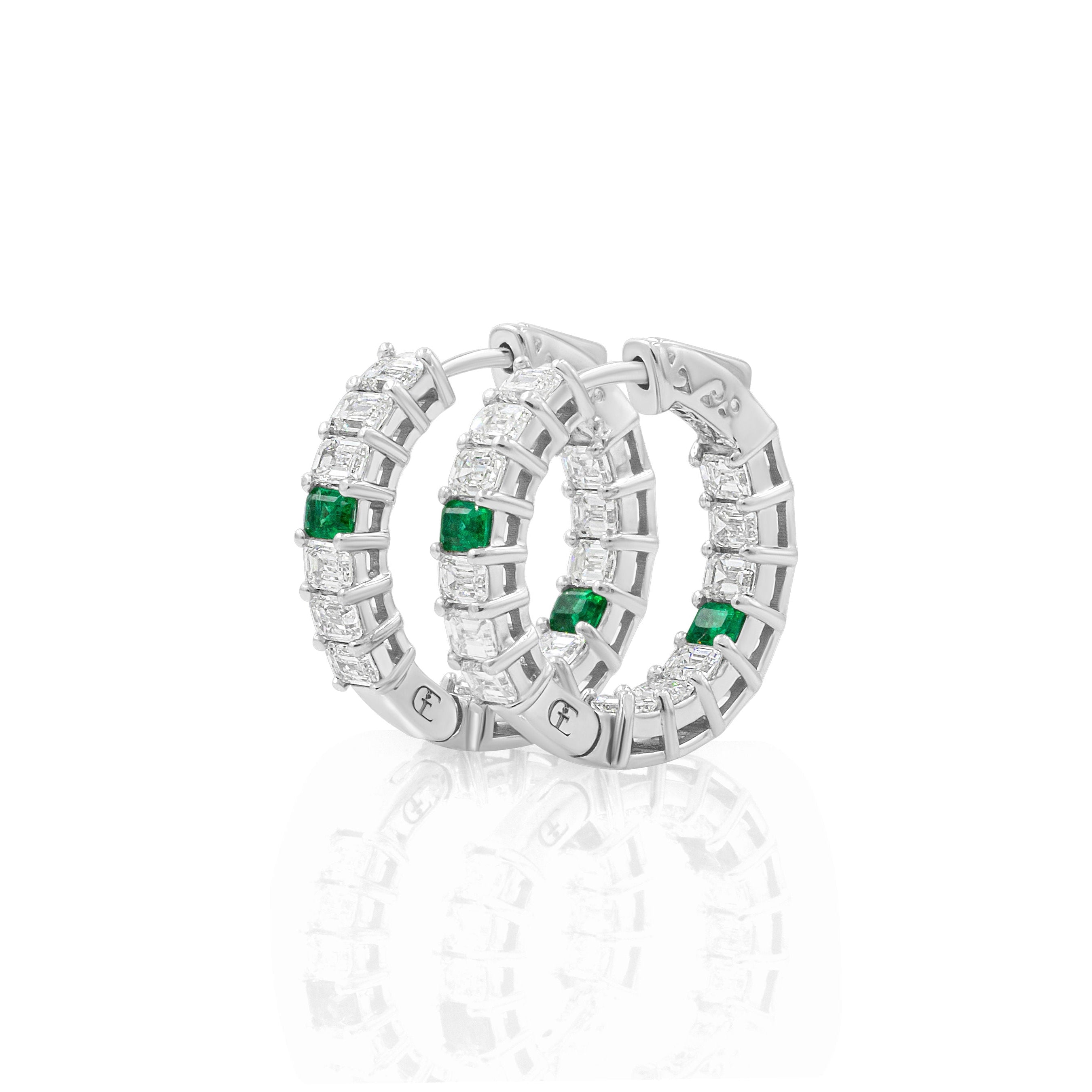 Pair of goldhoop earrings with green gemstones