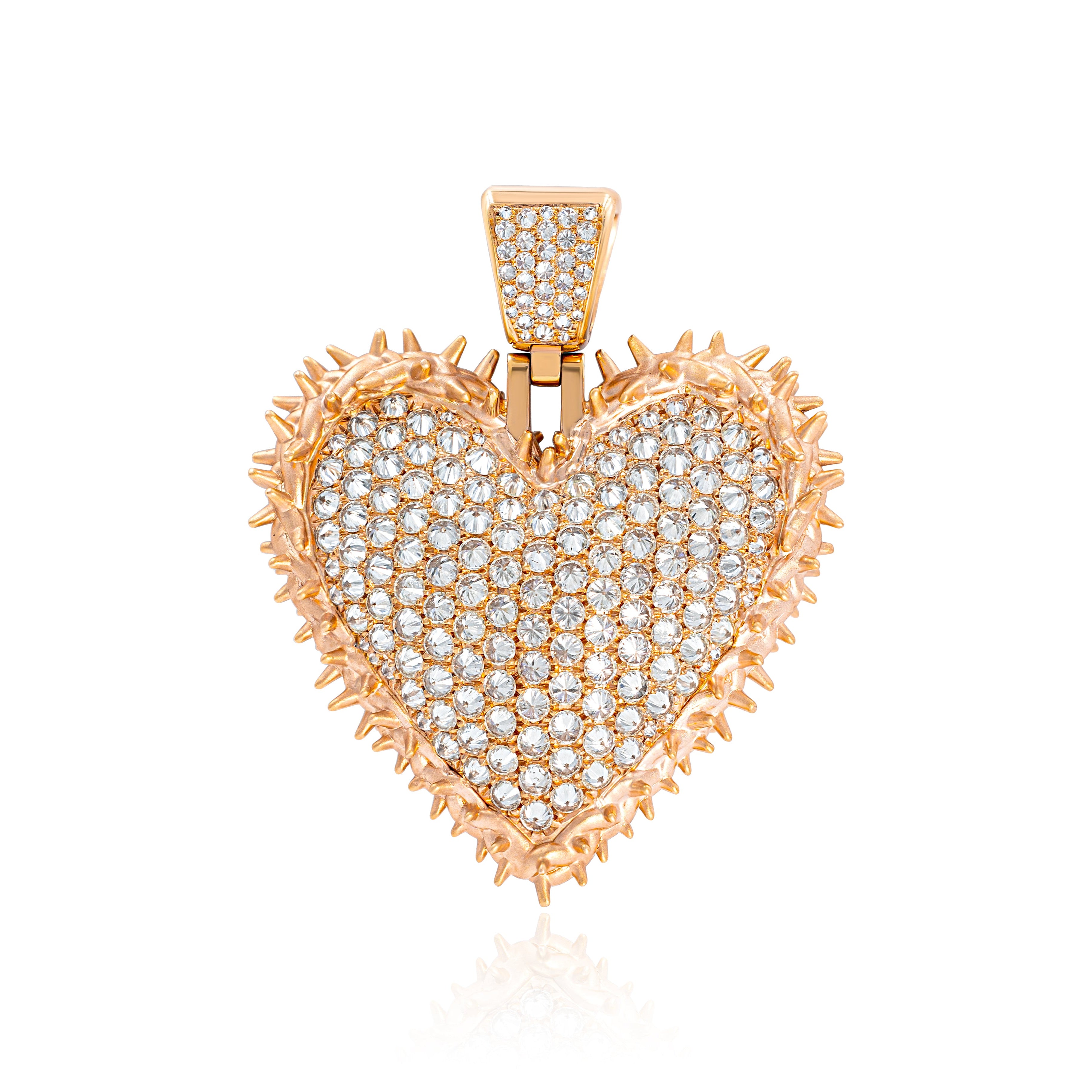 A heart-shaped pendant with a rose gold color and encrusted with diamond-like stones.