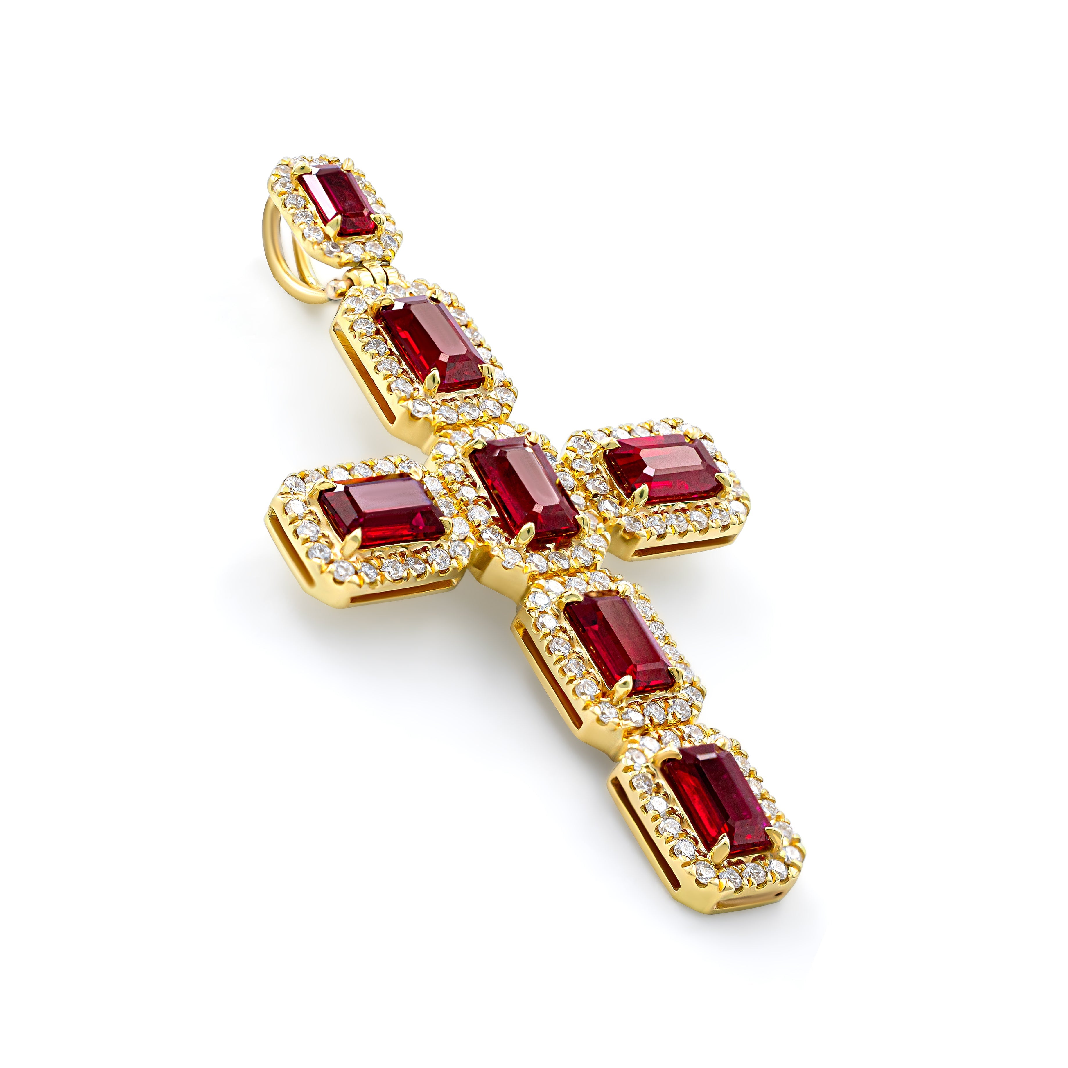 A gold cross pendant adorned with red rubies and small white diamonds.