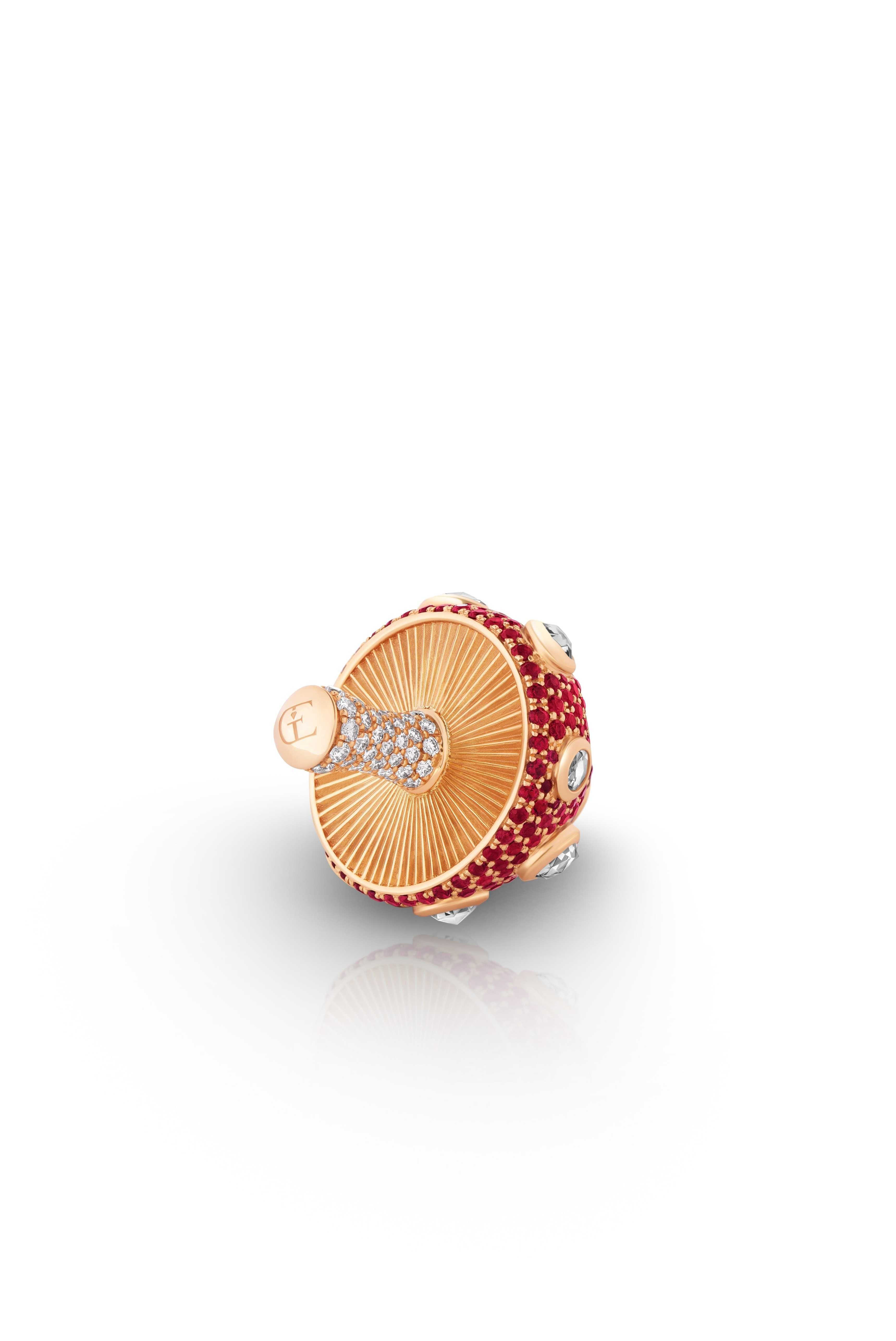 Mushroom-shaped jewelry piece with red gemstones and gold accents on a pendant