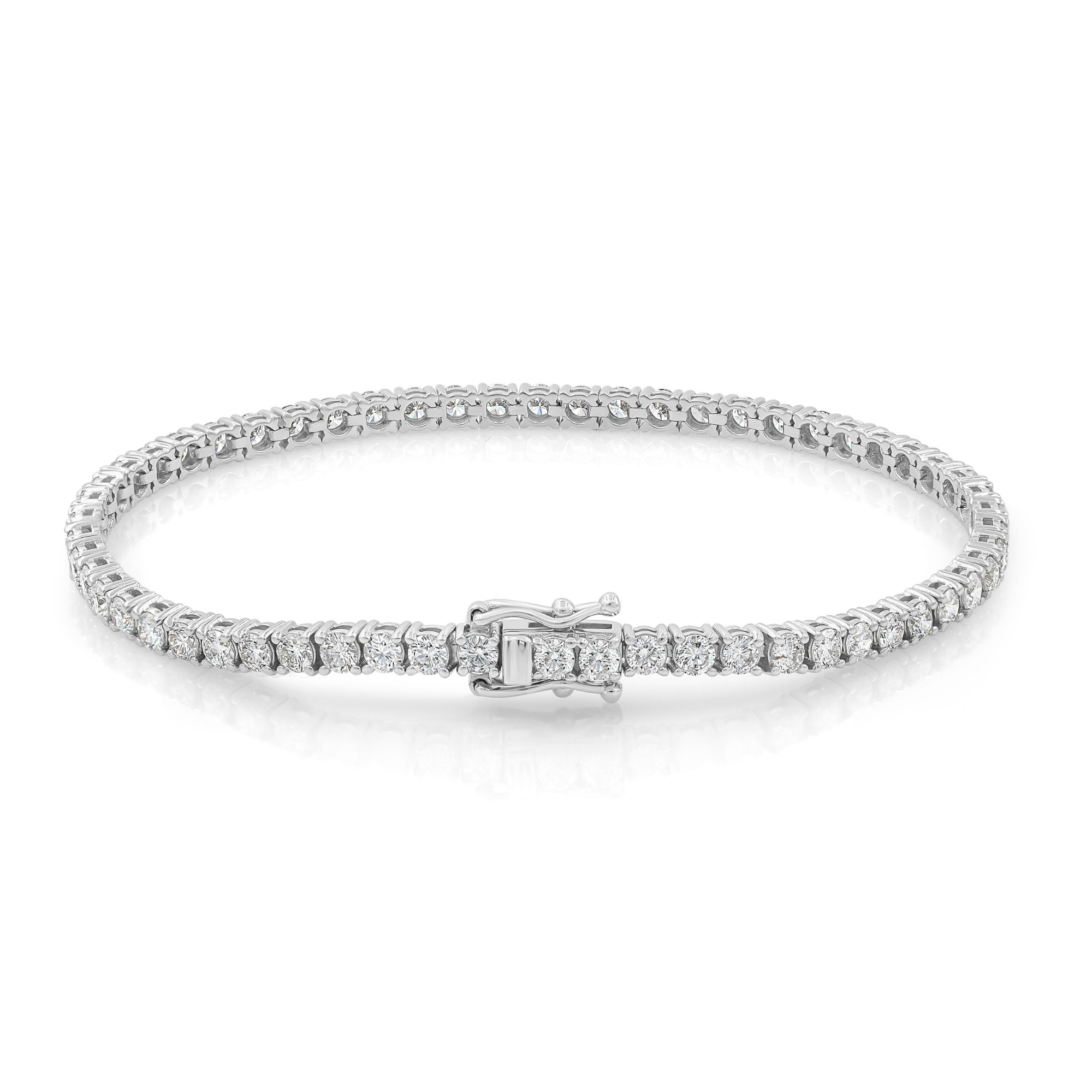 A white gold tennis bracelet with sparkling diamonds.