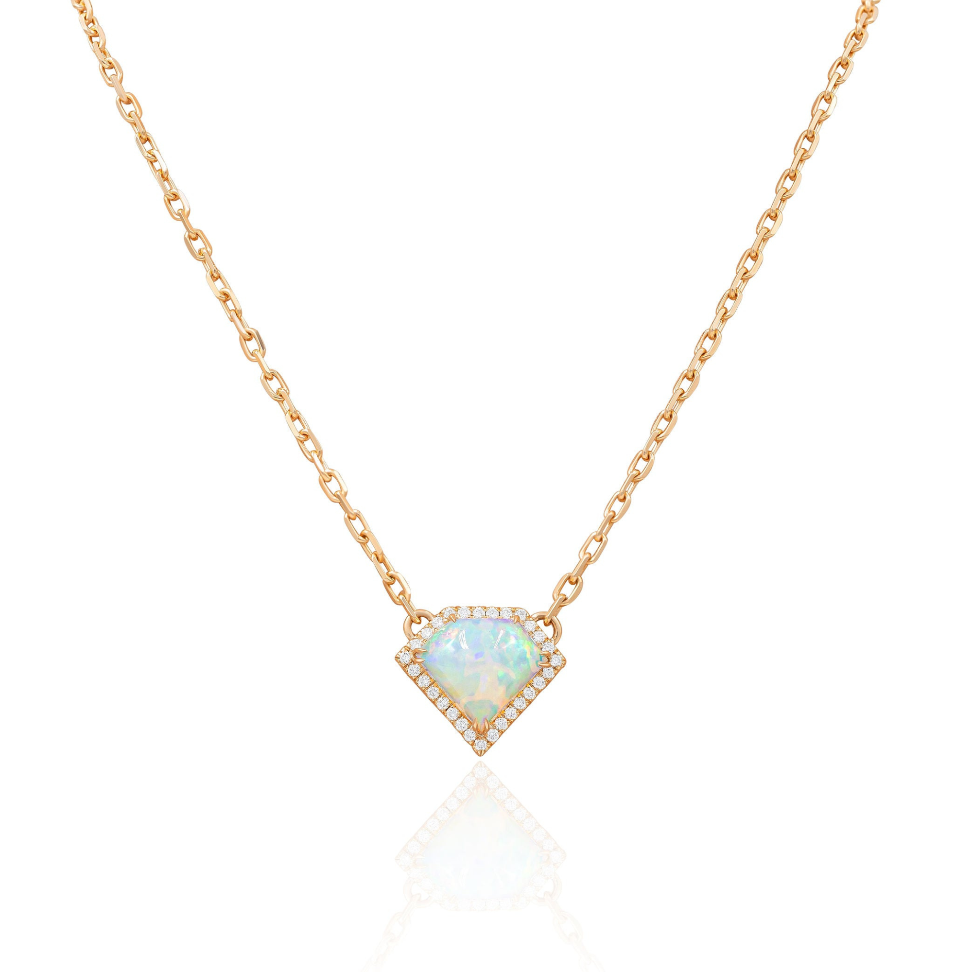 A rose gold pendant necklace with a shield cut opal center charm and diamond accents around the border