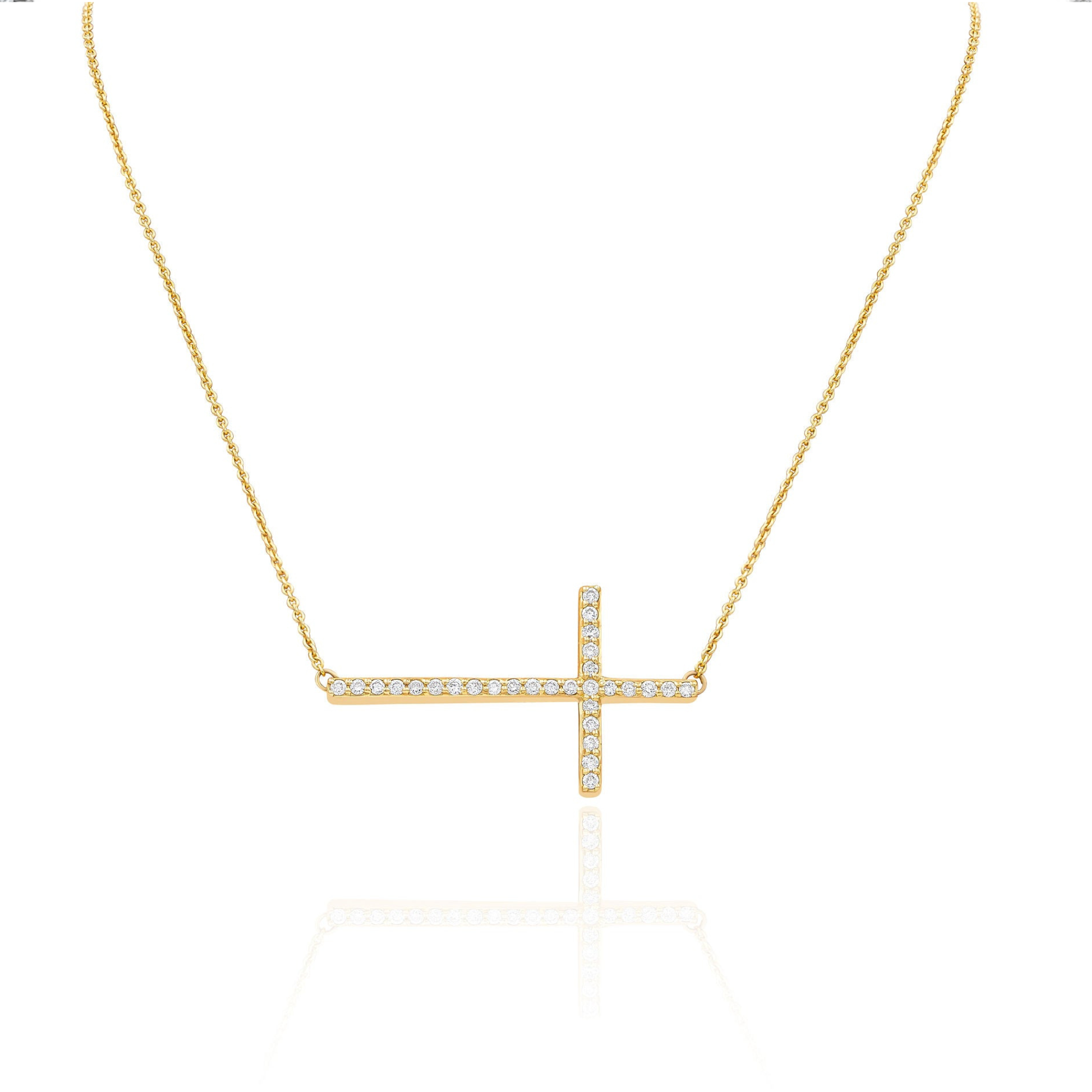 A 14KT yellow gold necklace with a diamond cross charm pendant on a white background.