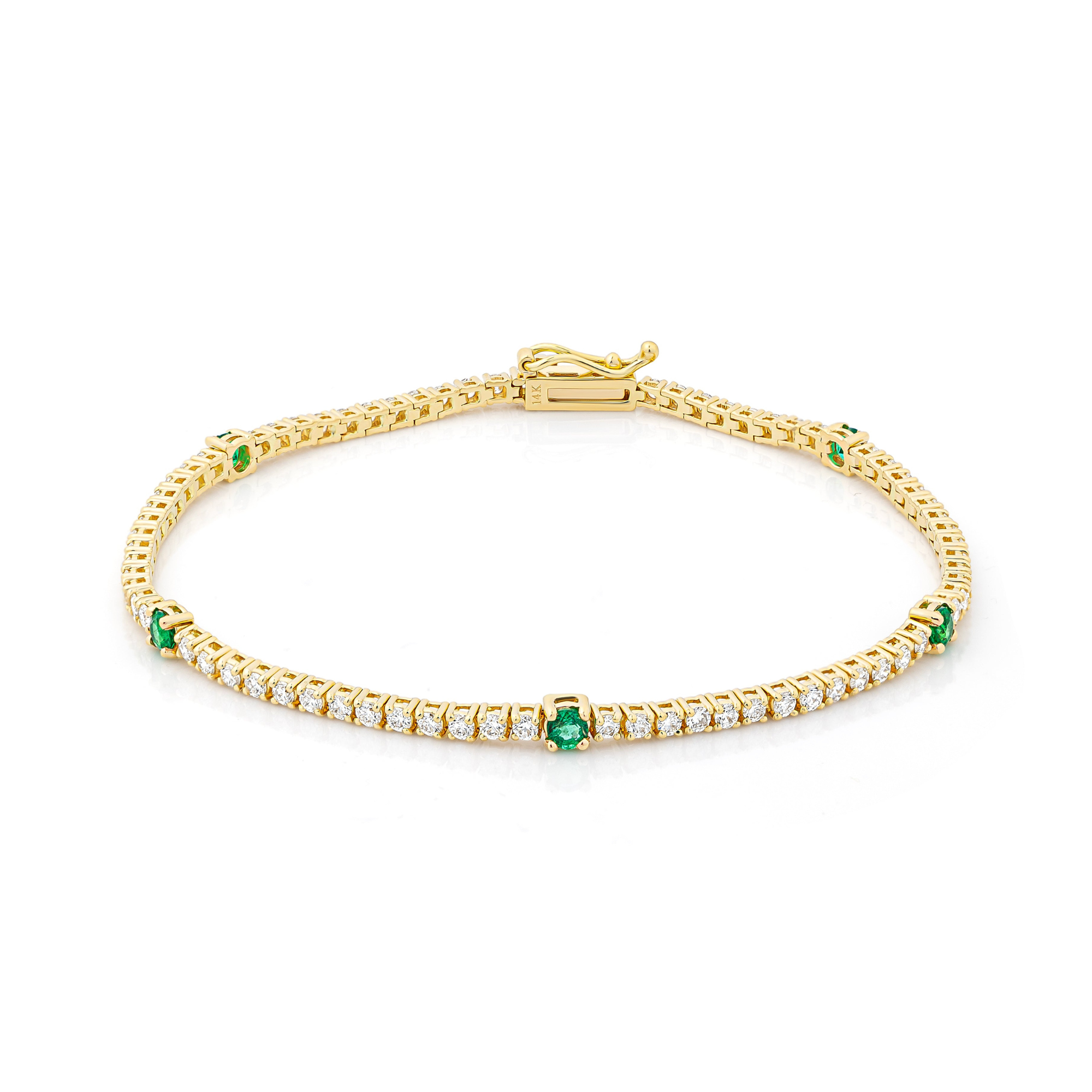 A gold tennis bracelet with diamond and emerald accents.