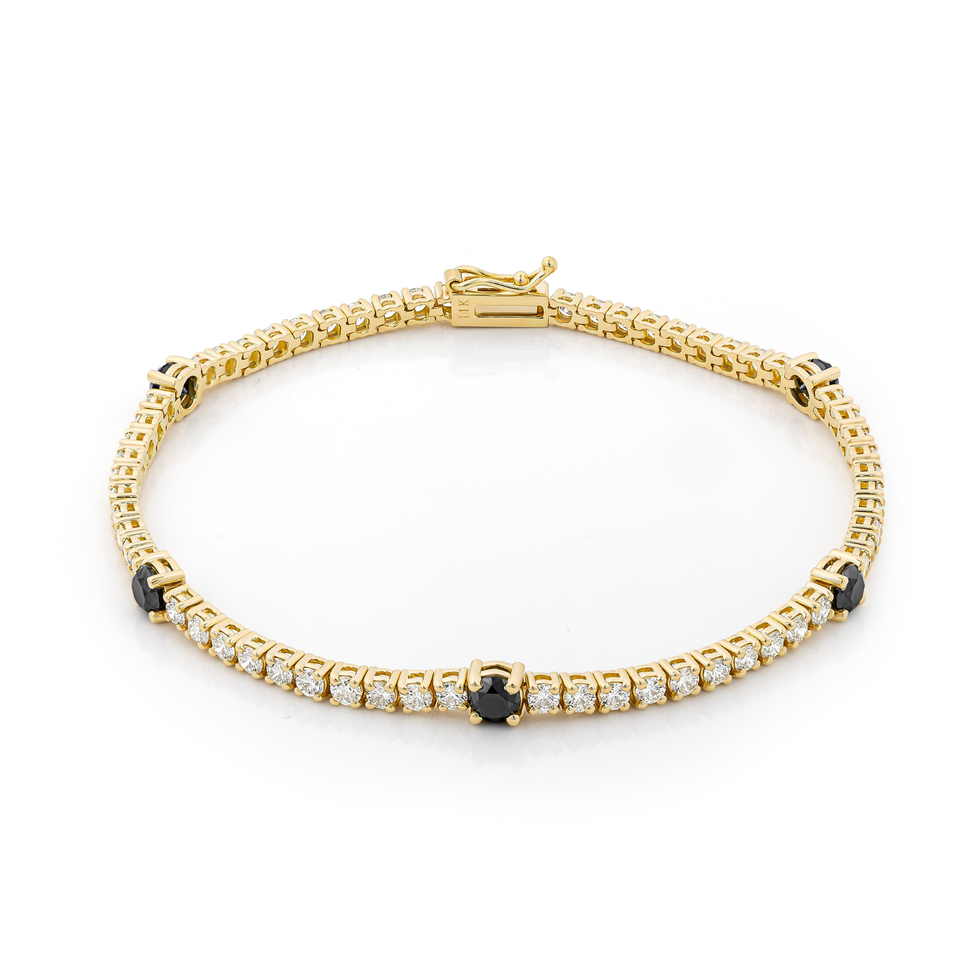 A tennis bracelet featuring black and white stones set in gold.