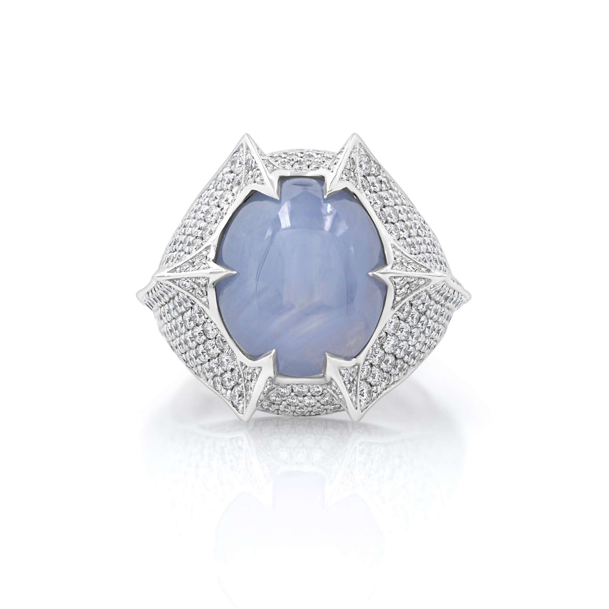 A ring with a large blue sapphire center stone surrounded by a smaller diamond band, set in a white gold mounting.