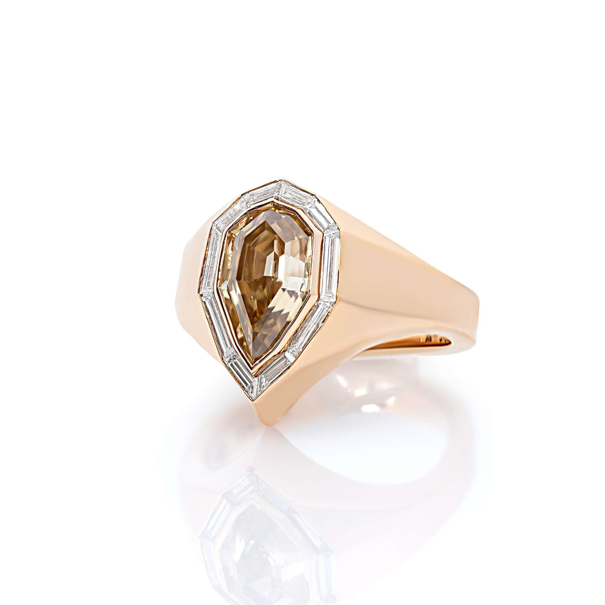 A rose gold-colored ring featuring a prominent pear-shaped diamond centerpiece