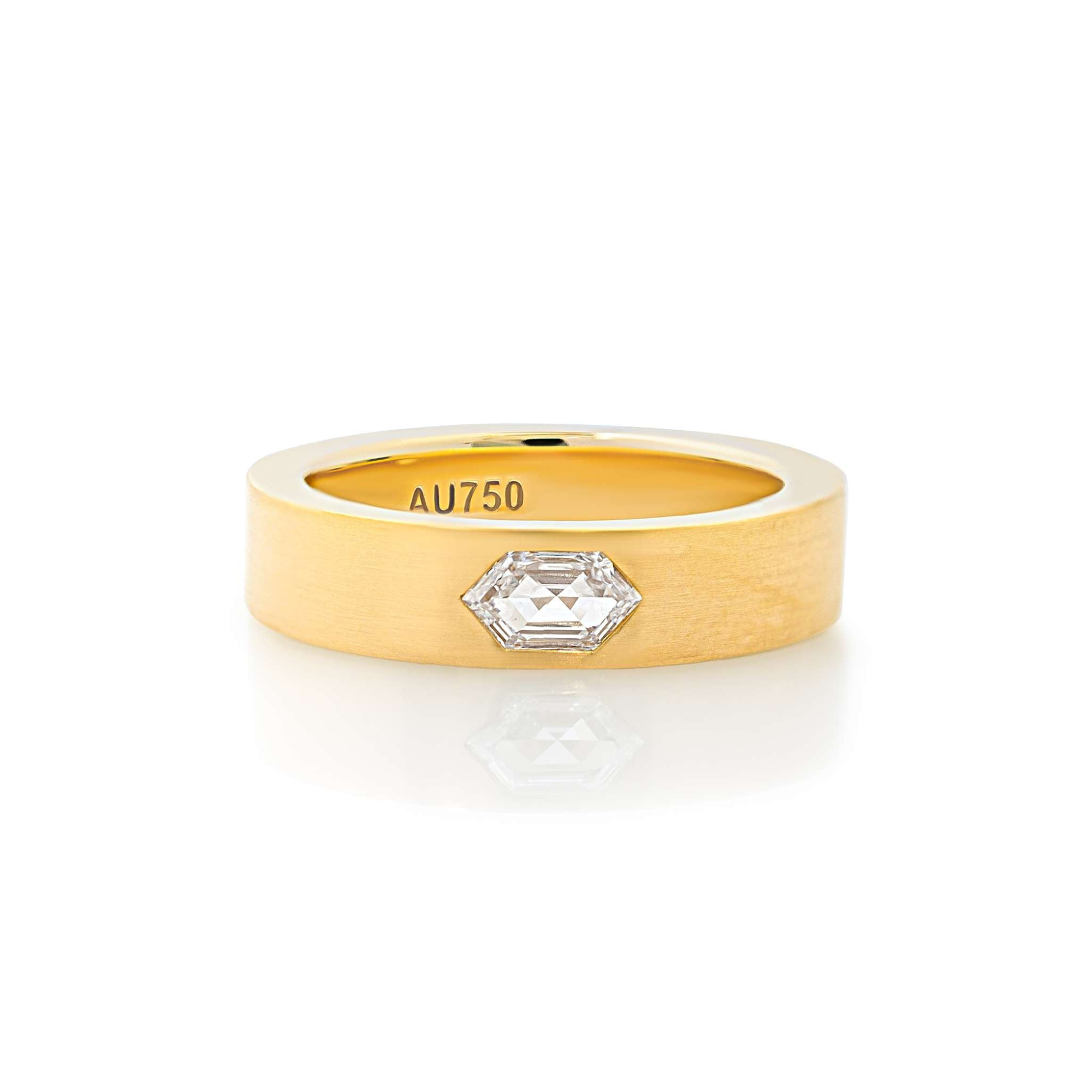 A yellow gold band ring with a small clear diamond set on top